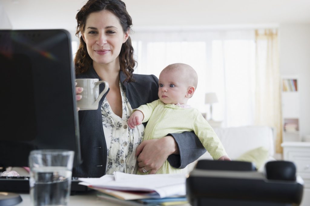 Picture shows the flexibility of working from home for a new mom.
