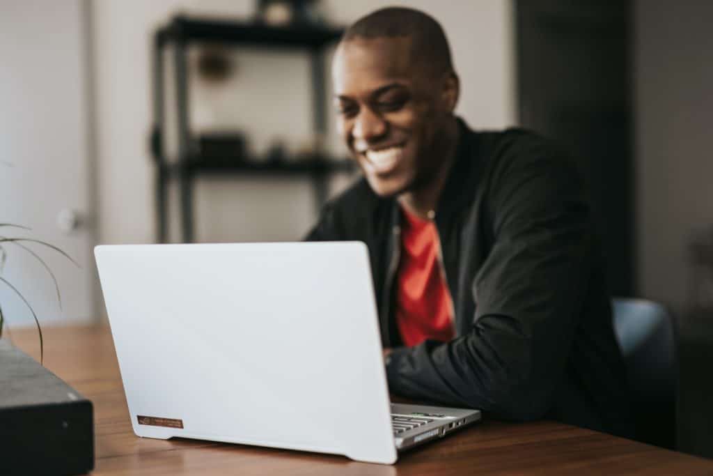 Image shows a man at his laptop using Organization Explorer.