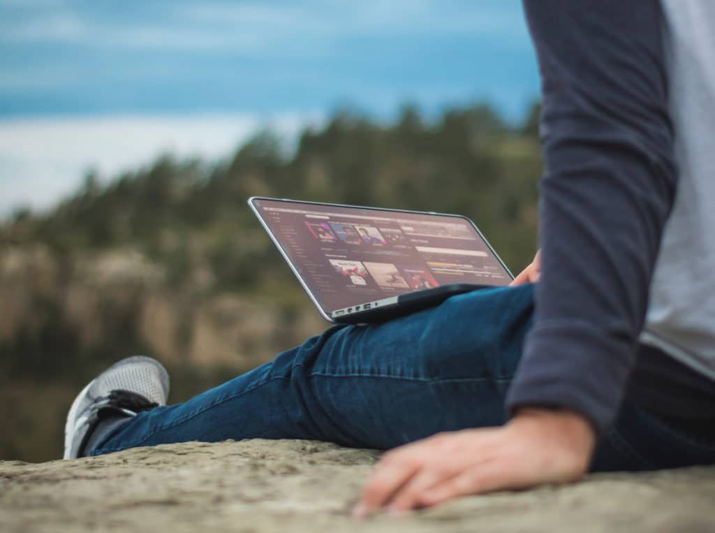 Image of a person using a laptop outside