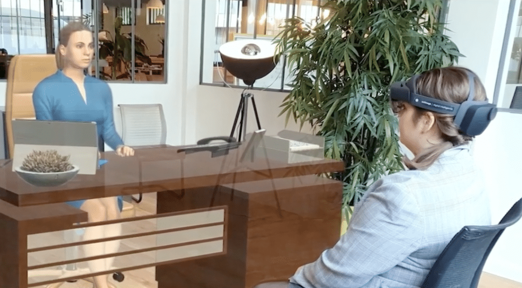 Image shows a user in a mixed reality setting practicing for a job interview.