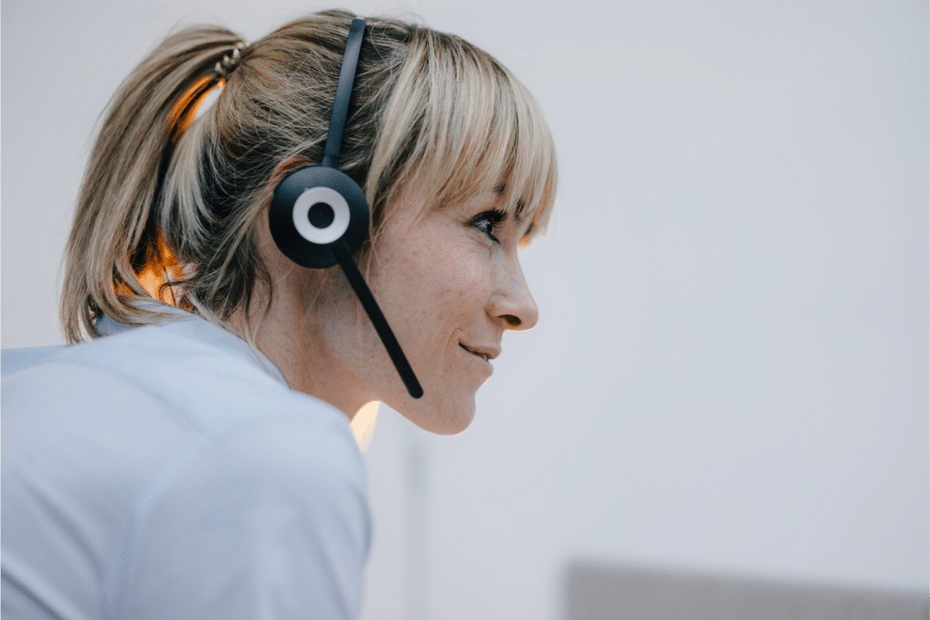 Woman with headset shows her customer-first approach.