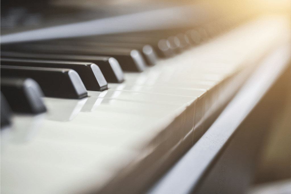 Image of piano keys suggests both traditional instrumentation and machine learning for music therapy.