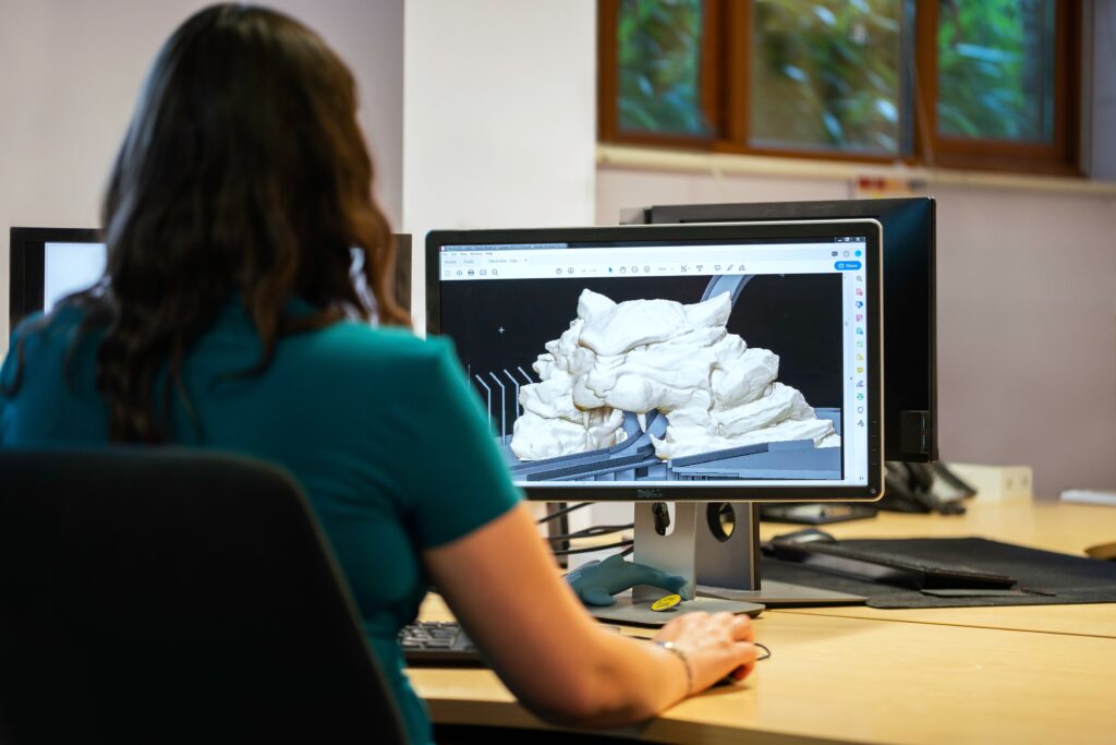 Image shows a student designing a 3D model.